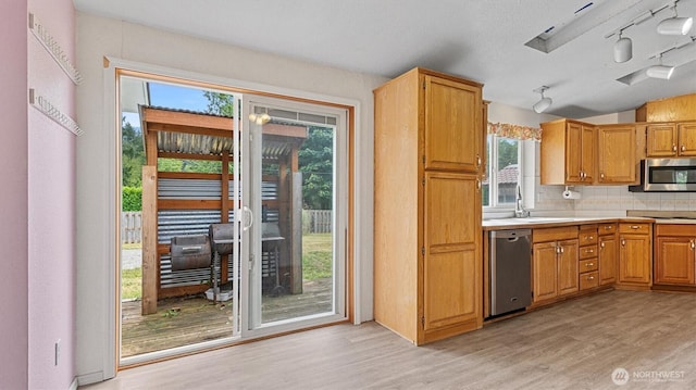 41427 Mountain View Pl E, Gold Bar, WA 98251 - kitchen featuring appliances with stainless steel finishes, light wood finished floors, track lighting, healthy amount of natural light, and lofted ceiling