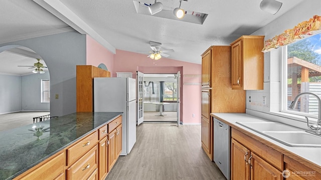 41427 Mountain View Pl E, Gold Bar, WA 98251 - kitchen with freestanding refrigerator, ceiling fan, stainless steel dishwasher, arched walkways, and ornamental molding