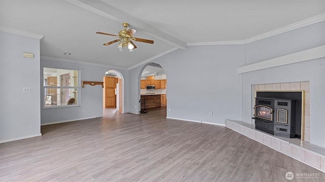41427 Mountain View Pl E, Gold Bar, WA 98251 - unfurnished living room featuring ceiling fan, wood finished floors, arched walkways, and ornamental molding