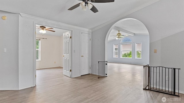 41427 Mountain View Pl E, Gold Bar, WA 98251 - unfurnished room with ceiling fan, ornamental molding, arched walkways, wood finished floors, and vaulted ceiling