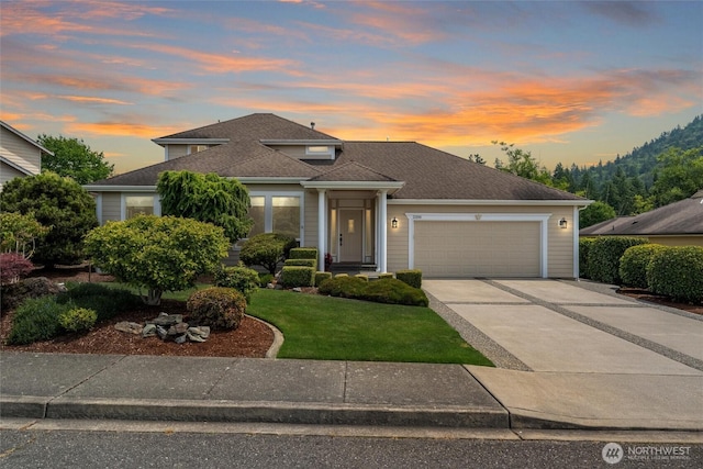 2108 S 18th St, Mount Vernon, WA 98274 - view of front facade featuring an attached garage, concrete driveway, a front yard, and roof with shingles