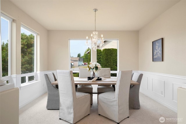 2108 S 18th St, Mount Vernon, WA 98274 - carpeted dining area with a chandelier, healthy amount of natural light, a wainscoted wall, and a decorative wall