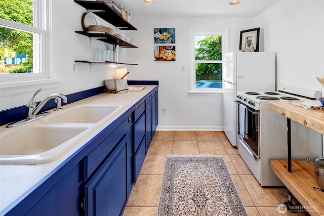 2711 NW 80th St, Seattle, WA 98117 - kitchen with white appliances, blue cabinets, open shelves, light countertops, and recessed lighting