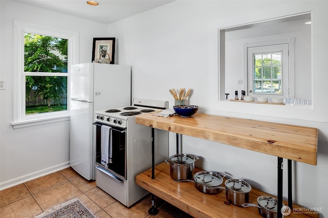 2711 NW 80th St, Seattle, WA 98117 - kitchen featuring white appliances and light tile patterned floors