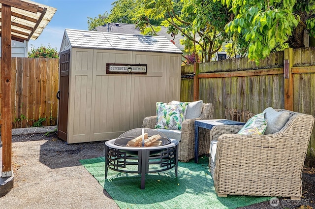 2711 NW 80th St, Seattle, WA 98117 - fenced backyard with a fire pit and a storage unit
