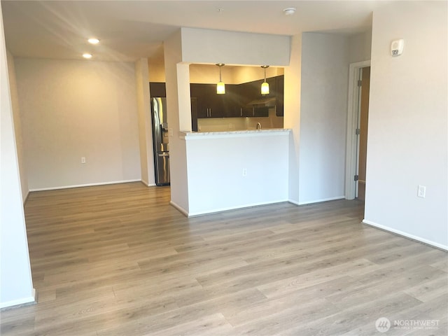 921 Westridge Way NE # 102, Issaquah, WA 98029 - unfurnished living room with light wood-type flooring and recessed lighting