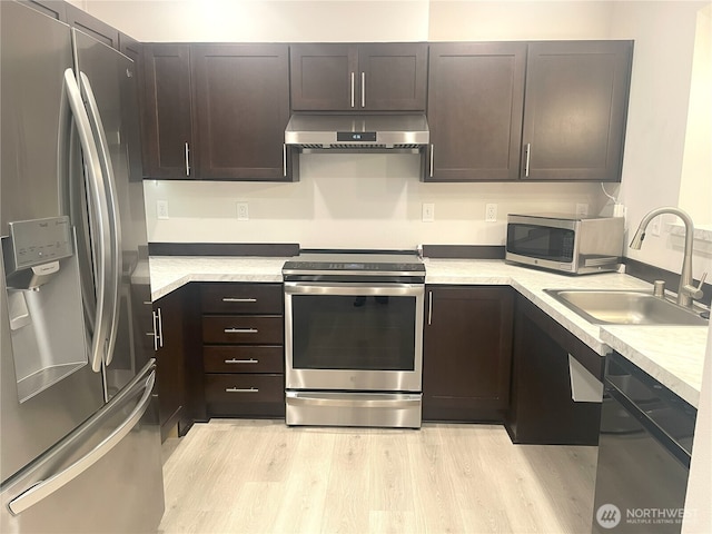 921 Westridge Way NE # 102, Issaquah, WA 98029 - kitchen featuring stainless steel appliances, extractor fan, light wood-type flooring, light countertops, and dark brown cabinets