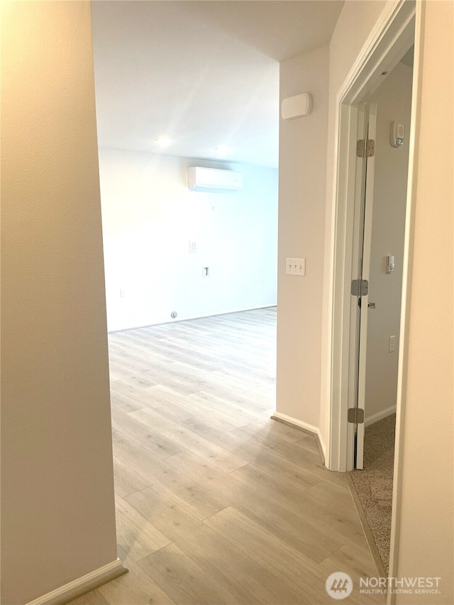 921 Westridge Way NE # 102, Issaquah, WA 98029 - corridor with a wall mounted air conditioner and light wood-style floors