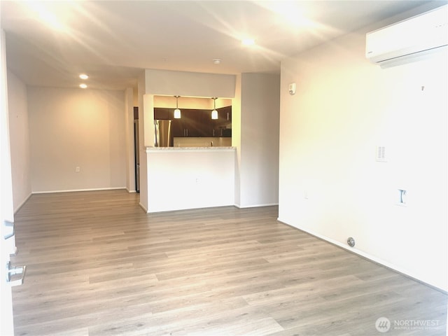 921 Westridge Way NE # 102, Issaquah, WA 98029 - unfurnished living room featuring a wall unit AC, light wood-type flooring, and recessed lighting