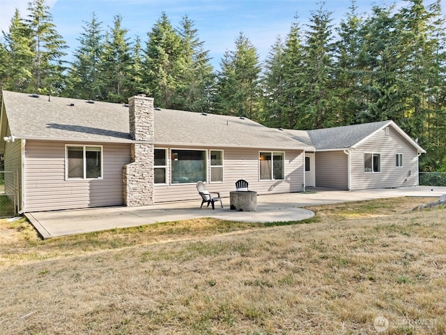 2733 Teal Lake Rd, Port Ludlow, WA 98365 - rear view of house with a patio area, a chimney, a yard, and a shingled roof