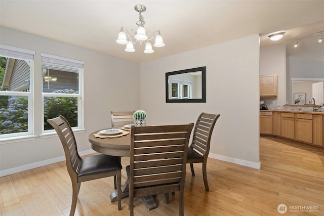 2733 Teal Lake Rd, Port Ludlow, WA 98365 - dining room with a chandelier and light wood-style floors