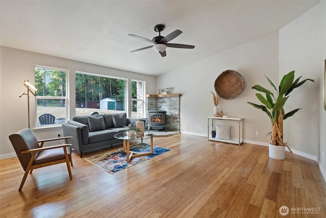 2733 Teal Lake Rd, Port Ludlow, WA 98365 - living room with a wood stove, light wood-type flooring, and a ceiling fan