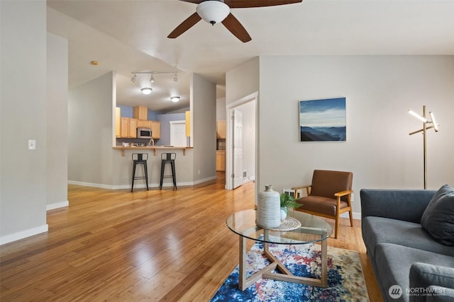 2733 Teal Lake Rd, Port Ludlow, WA 98365 - living room featuring light wood-style floors, a ceiling fan, track lighting, and lofted ceiling