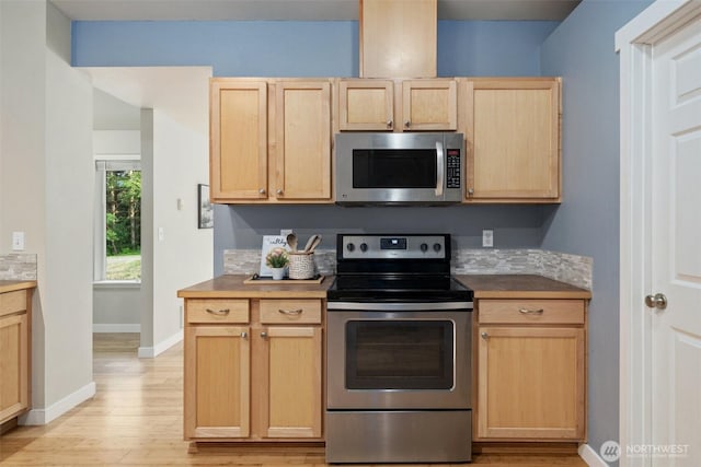 2733 Teal Lake Rd, Port Ludlow, WA 98365 - kitchen featuring stainless steel appliances, light brown cabinetry, and light wood-style flooring