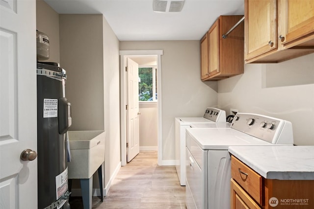 2733 Teal Lake Rd, Port Ludlow, WA 98365 - laundry area featuring washing machine and clothes dryer, cabinet space, and light wood-style floors