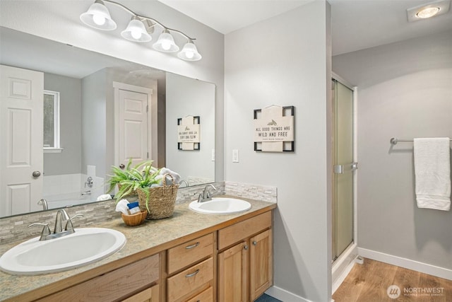 2733 Teal Lake Rd, Port Ludlow, WA 98365 - bathroom featuring a stall shower, double vanity, and wood finished floors