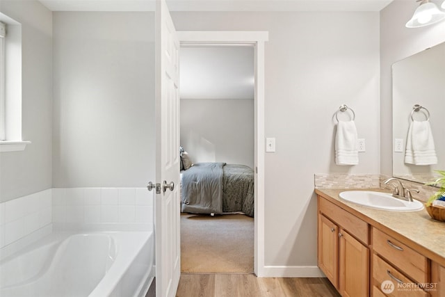 2733 Teal Lake Rd, Port Ludlow, WA 98365 - bathroom with vanity, a garden tub, wood finished floors, and ensuite bath