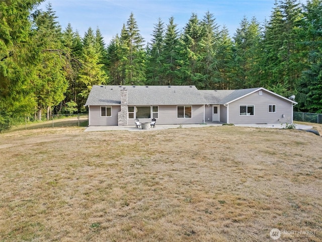 2733 Teal Lake Rd, Port Ludlow, WA 98365 - back of property with a patio, a chimney, and a forest view