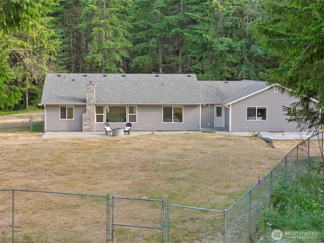 2733 Teal Lake Rd, Port Ludlow, WA 98365 - rear view of house with a gate, a fenced backyard, a chimney, and a patio