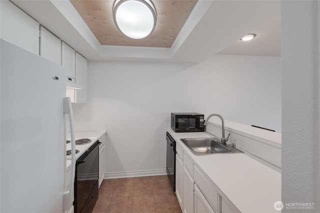 6055 35th Ave SW Unit 308, Seattle, WA 98126 - kitchen with black appliances, a raised ceiling, under cabinet range hood, white cabinetry, and light countertops