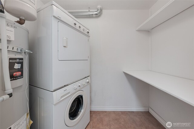 6055 35th Ave SW Unit 308, Seattle, WA 98126 - laundry area with stacked washing machine and dryer and light tile patterned floors