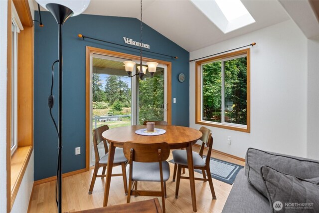 5207 170th St E, Tacoma, WA 98446 - dining area featuring healthy amount of natural light, a chandelier, light wood-style flooring, and vaulted ceiling