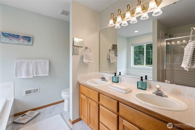 5207 170th St E, Tacoma, WA 98446 - bathroom with double vanity, a stall shower, a garden tub, and marble finish flooring
