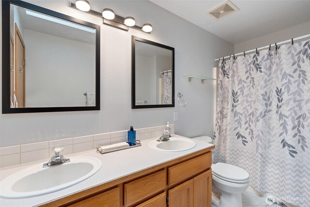 5207 170th St E, Tacoma, WA 98446 - bathroom featuring double vanity, curtained shower, and backsplash