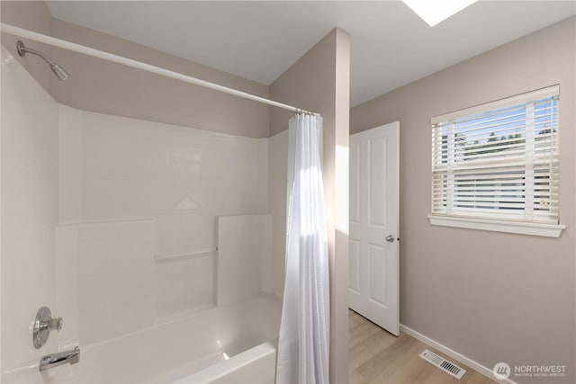 16107 NE 90th Way Unit 3304, Redmond, WA 98052 - bathroom featuring shower / bath combination with curtain and wood finished floors