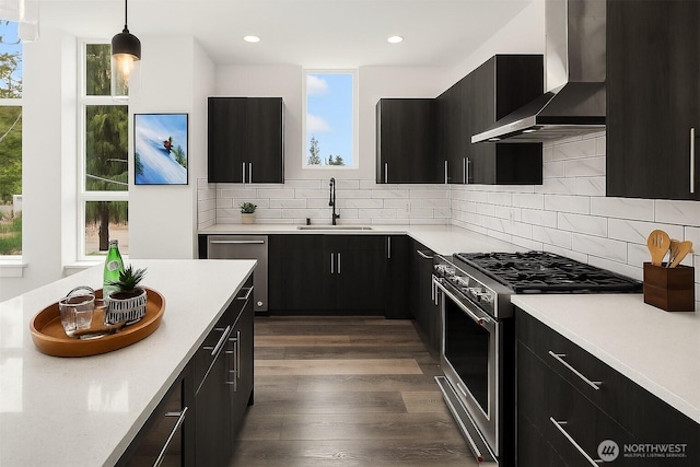 16547 NE 92nd Pl Unit 6A, Redmond, WA 98052 - kitchen with appliances with stainless steel finishes, wall chimney range hood, dark cabinets, light countertops, and recessed lighting