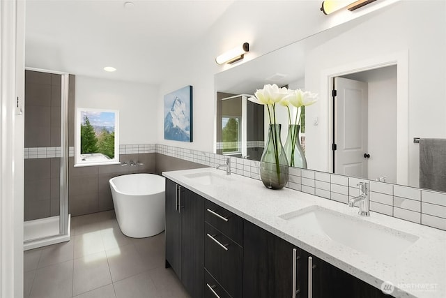 16547 NE 92nd Pl Unit 6A, Redmond, WA 98052 - bathroom featuring double vanity, a freestanding tub, a shower stall, tile walls, and tile patterned flooring