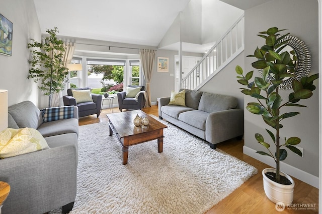 21227 SE 29th St, Sammamish, WA 98075 - living room featuring stairway, vaulted ceiling, and wood finished floors