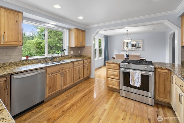 21227 SE 29th St, Sammamish, WA 98075 - kitchen with appliances with stainless steel finishes, light wood-style floors, crown molding, tasteful backsplash, and stone countertops