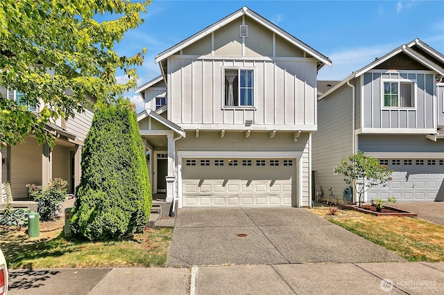 4023 Tribute Ave E, Fife, WA 98424 - view of front of house with board and batten siding, a garage, and driveway