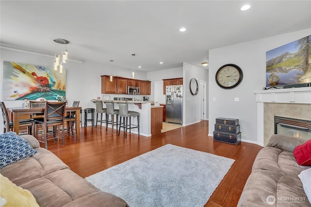 4023 Tribute Ave E, Fife, WA 98424 - living area with recessed lighting, wood finished floors, a tiled fireplace, and a chandelier