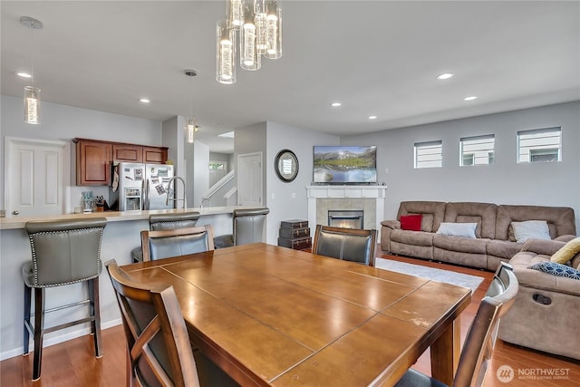 4023 Tribute Ave E, Fife, WA 98424 - dining room with wood finished floors, a fireplace, recessed lighting, and a chandelier