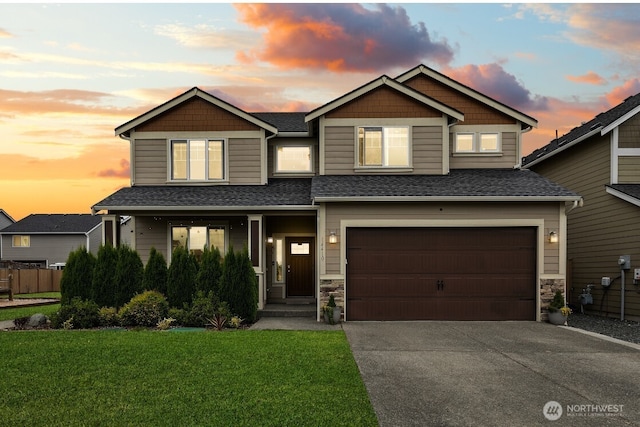 14410 99th Way SE, Yelm, WA 98597 - craftsman house featuring driveway, an attached garage, a shingled roof, and stone siding