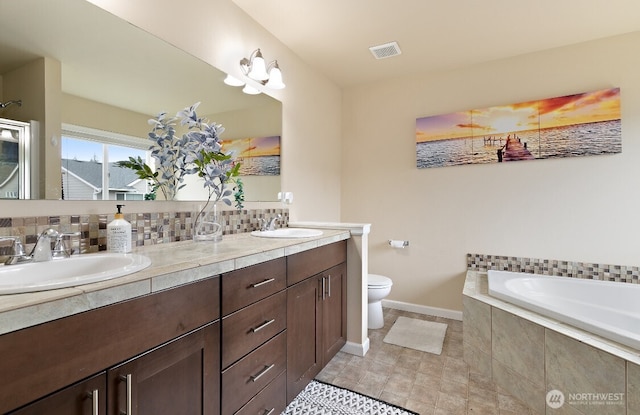 14410 99th Way SE, Yelm, WA 98597 - bathroom with double vanity, a garden tub, backsplash, and tile patterned floors