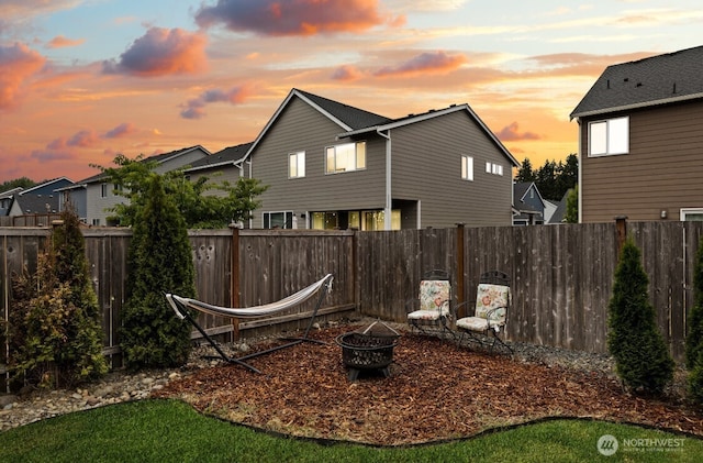 14410 99th Way SE, Yelm, WA 98597 - yard at dusk featuring an outdoor fire pit and a fenced backyard