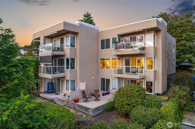 2241 13th Ave W, Seattle, WA 98119 - rear view of property featuring stucco siding, a patio area, and a balcony