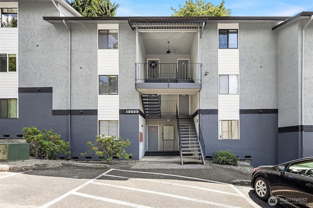 12023 100th Ave NE Unit C4, Kirkland, WA 98034 - view of property featuring stairs and uncovered parking