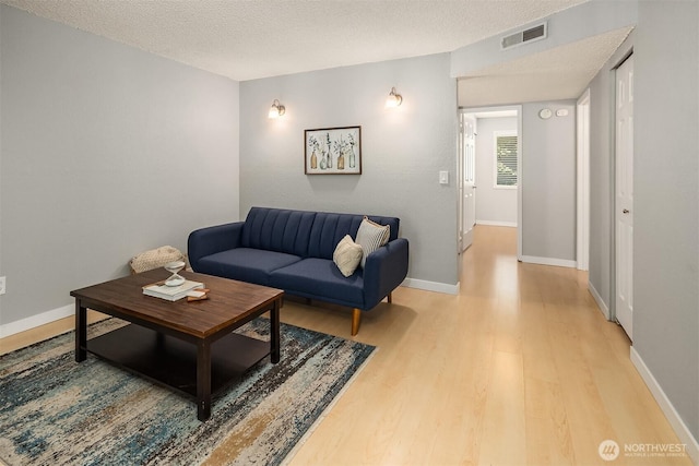 12023 100th Ave NE Unit C4, Kirkland, WA 98034 - living room featuring light wood finished floors and a textured ceiling