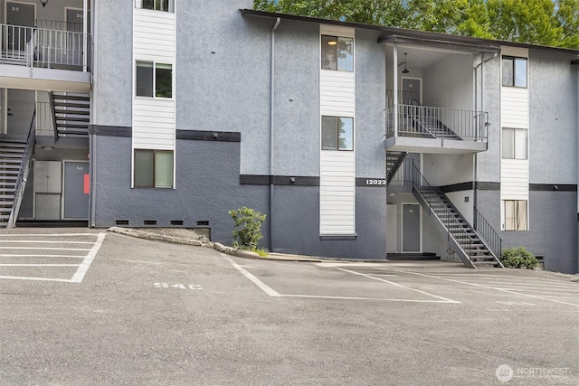 12023 100th Ave NE Unit C4, Kirkland, WA 98034 - view of property with stairs and uncovered parking