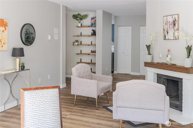 8845 166th Ave NE Unit B101, Redmond, WA 98052 - sitting room featuring light wood finished floors and a brick fireplace