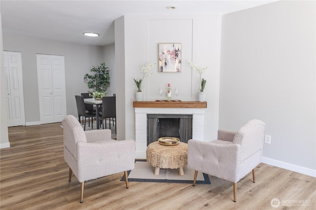 8845 166th Ave NE Unit B101, Redmond, WA 98052 - living room with wood finished floors, a brick fireplace, and recessed lighting