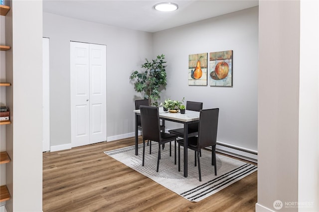 8845 166th Ave NE Unit B101, Redmond, WA 98052 - dining room featuring wood finished floors and a baseboard heating unit