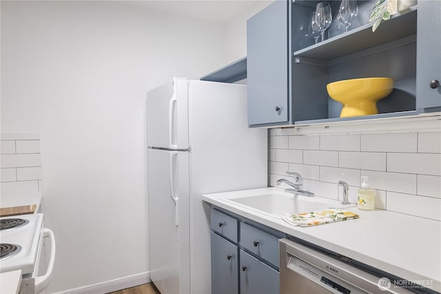 8845 166th Ave NE Unit B101, Redmond, WA 98052 - kitchen featuring white appliances, open shelves, backsplash, light countertops, and gray cabinets