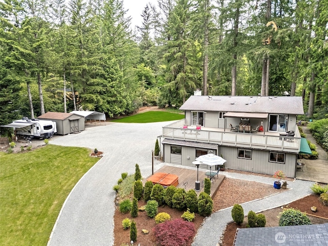 14531 262nd Ave SE, Issaquah, WA 98027 - rear view of house with a deck, a lawn, and a chimney