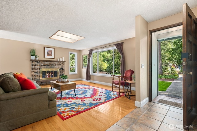 14531 262nd Ave SE, Issaquah, WA 98027 - tiled living area featuring plenty of natural light, a textured ceiling, a fireplace, and a skylight