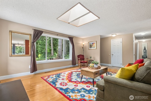 14531 262nd Ave SE, Issaquah, WA 98027 - living room with light wood-style flooring, a skylight, and a textured ceiling